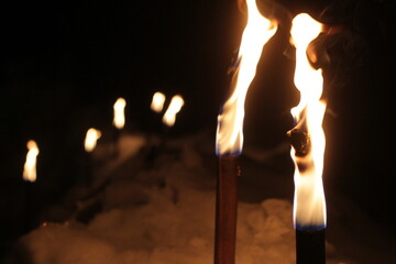 Group of candles are lit in the snow