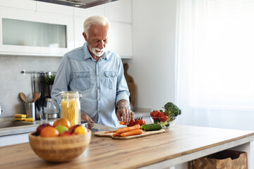 Salad and old man cooking food for a healthy dinner dish with fresh organic green vegetables and...
