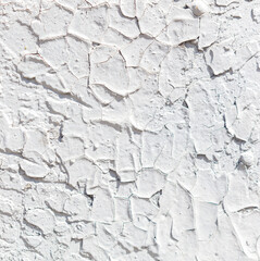 The wall is covered in cracks and peeling paint, giving it a worn