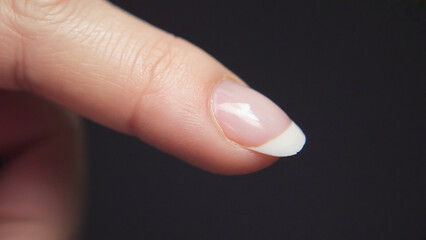 Elegant Fingertip: A close-up study of an elegant fingertip, highlighting the natural beauty of the hand with a focus on a manicured nail, offering a sense of delicacy and care.