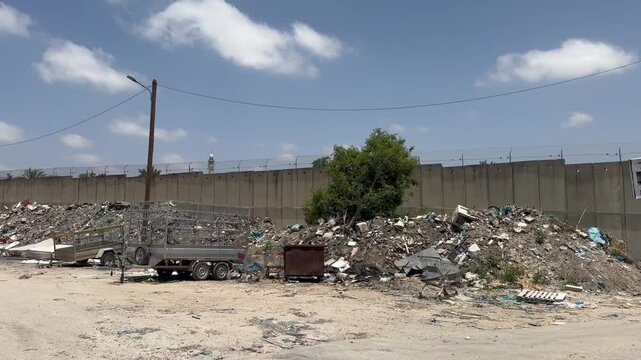Bartaa, Israel &ndash; May 22, 2025. A garbage dump near the Separation barrier dividing the village between Israel and the Palestinian Authority.