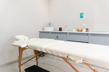 Massage table with face hole in empty therapy room