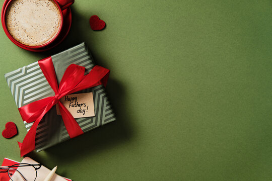 Father's day gift and coffee on green background