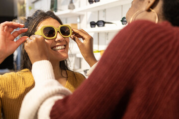 Friendly shopping for sunglasses in a modern store