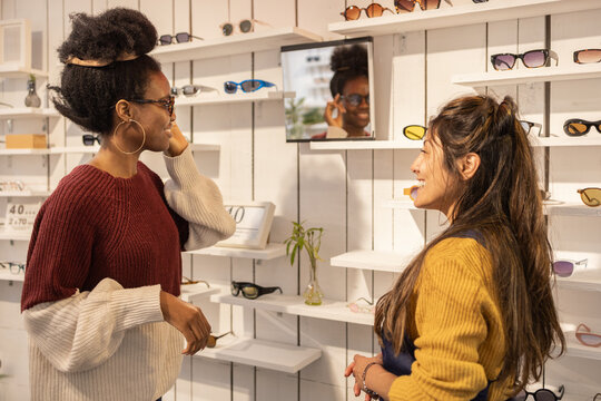 Customer trying on sunglasses in chic store setting
