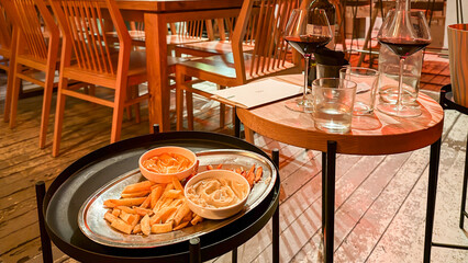 Golden fries with zesty aioli on rustic patio evoke cozy autumn brunch or quirky holiday Tapas Night