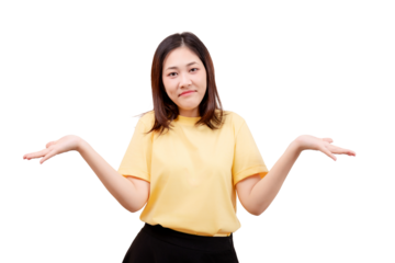Asian young beautiful in a yellow shirt shrugging with both hands raised, expressing uncertainty or confusion.