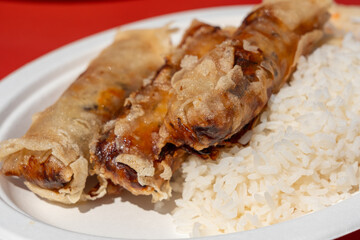Fried spring rolls. Crispy springrolls, roasted egg rolls with boiled rice and cabbage salad