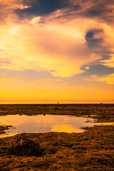 Sunset view on the beach where the water is receding