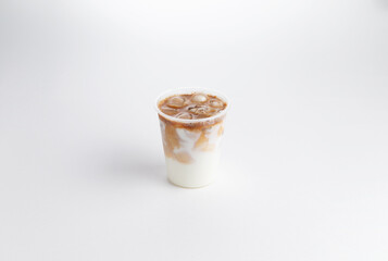 Cold coffee with milk in a glass. on a white background.