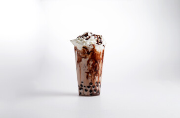 Milkshake with chocolate syrup and whipped cream in a glass. on a white background.