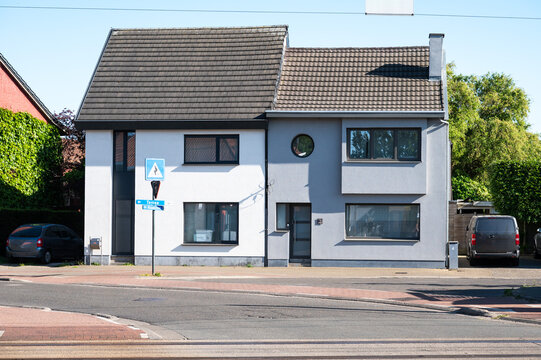 Semi detached houses and parked car at the railway station of Nieuwkerken Waas, Sint Niklaas, Belgium