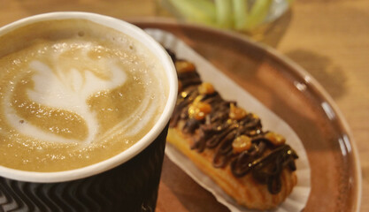Creamy Coffee and Craft Choco Eclair Cake Decorated with Gilded Nuts and Chocolate Icing on a...