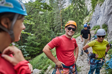 Climbers prepare for an adventure in the mountains on a sunny day surrounded by nature