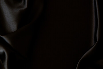 Beautiful elegant black silk fabric background. Top view