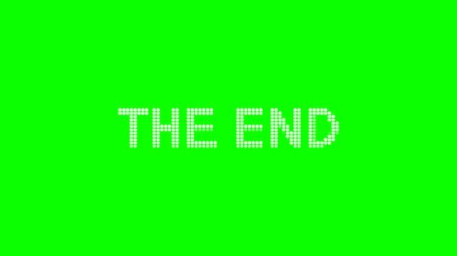White "the end" credits are formed by particles arriving from the side and disintegrating into particles to the side. Chroma key, mockup, аnimation, loop, isolated green screen