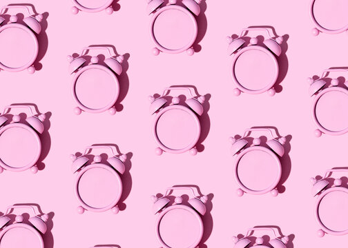 Pink retro alarm clock, creative pastel pink background