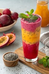 Layered Magenta and Orange Chia Seed Smoothie with Fresh Mint and Grapefruit on Blurred Background