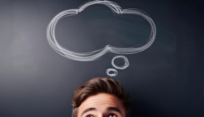 A thought bubble drawn on a chalkboard above a persons head representing ideas or thinking