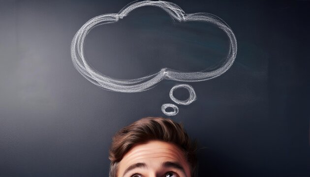 A thought bubble drawn on a chalkboard above a persons head representing ideas or thinking