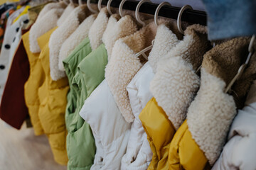Clothing store. Casual clothes for children. Outerwear for children. Vests with beautiful...