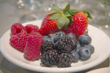 Fresh assortment of strawberries, blackberries, raspberries, and blueberries, perfect as vibrant garnishes for cocktails.