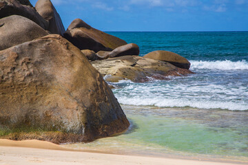 Large granite stones in blue Indian Ocean, Mahe Island, the Seychelles