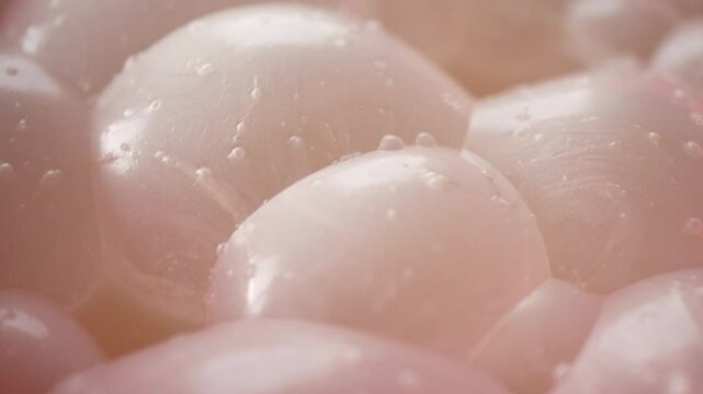Extreme close-up video of multi colored bubbles on the food surface