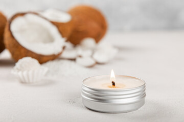 Natural coconut wax candles on a wooden table. Homemade eco-friendly coconut wax candles with aromatic oil. Candles for massage. Spa. Relax. Aromatherapy. Copy space. Vegan product.