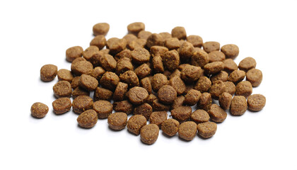 Pet food kibbles spread on white background with soft shadow