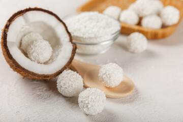 Coconut candies on a wooden background. Candies with chocolate, almonds and delicate butter cream. Coconut flakes. tasty sweets.Tasty ball-shaped chocolate candies.Dessert. Space for text.copy space