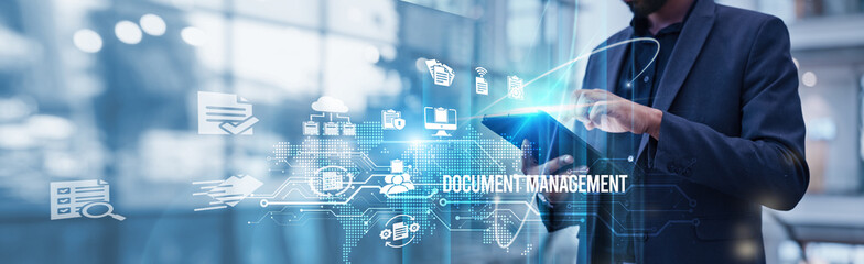 Businessman using tablet analyzing document management and digital transformation growth strategies to enhance operational efficiency and streamline information workflow across the organization.