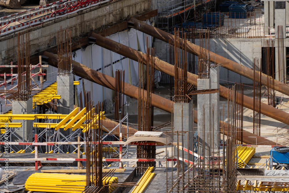 Poster infrastructure project: overview of a large structure being built with concrete pillars and metal re