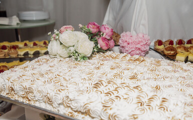 top view of a cake with white icing on a desert table at a buffet