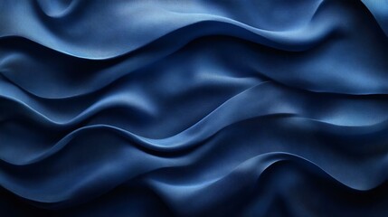 Obraz premium Close-up of luxurious dark blue fabric with elegant folds and waves, creating a rich texture. Ideal for backgrounds and textile design.