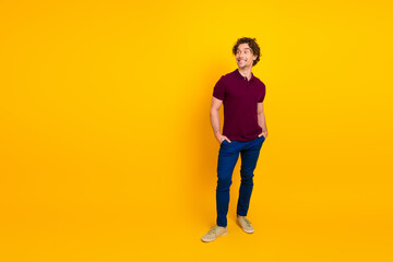 Portrait of a cheerful young man in casual fashion posing against a vibrant yellow backdrop showcasing modern style