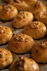 Ruddy homemade little pies sprinkled with sesame seeds on top