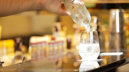 Closeup bartender hand in poring fresh soda gas texture into glass of drink advertisement serving customer at beverage bar counter luxury pub for welcome impression greeting guess service. Vinosity.