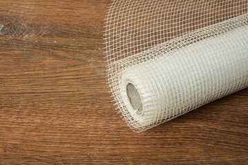 The roll of the fiberglass mesh reinforcement near insulated wall. Selective focus.