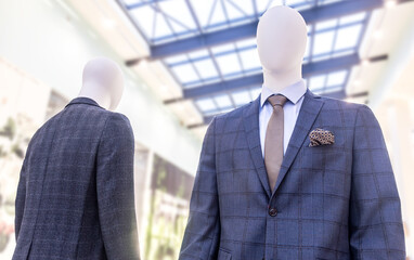 Male mannequins in elegant suits with a ties