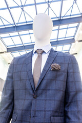 Male mannequin dressed in elegant suit with a tie