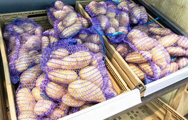 Fresh potatoes packed in bags selling at the grocery store