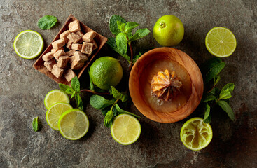 Wooden citrus squeezer and ingredients for making summer refreshing drinks.
