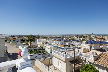 Rooftop Corner View with Satellite Dish and Hillside Homes