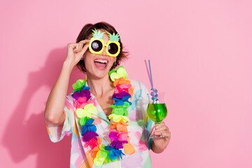 Portrait of nice young lady hold cocktail empty space wear shirt isolated on pink color background