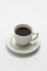 White cup of coffee on a gray background