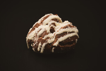 Profiteroles with coconut cream on a black background.