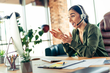 Young businesswoman in formal attire engaging during an online meeting in a corporate office environment