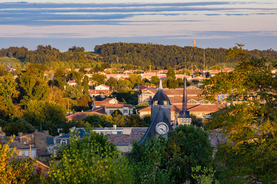 Blaye, Bordeaux region, France, general view of the city and vineyard in the foreground from the fortress citadel, sunny facades of buildings on the Cours du Port, peaceful and colorful summer evening