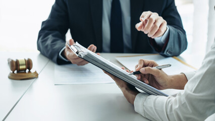 Businesswoman and Male lawyer or judge consult and conference having team meeting with client at...